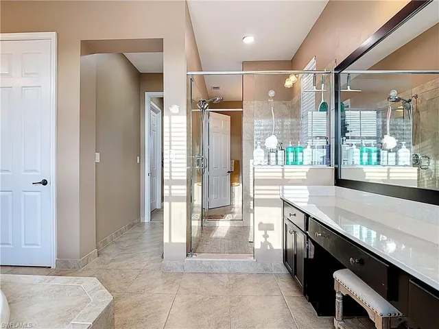 a bathroom with a glass shower door and a bathtub
