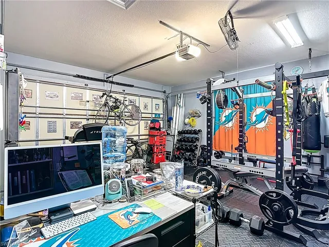 a view of swimming pool with lawn chairs and plants