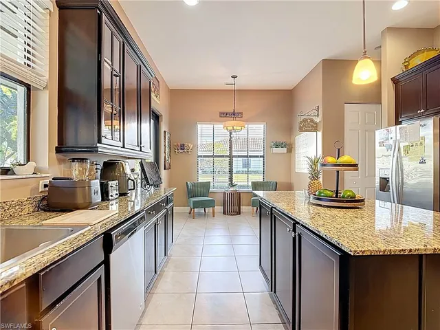 a kitchen with granite countertop a sink and cabinets