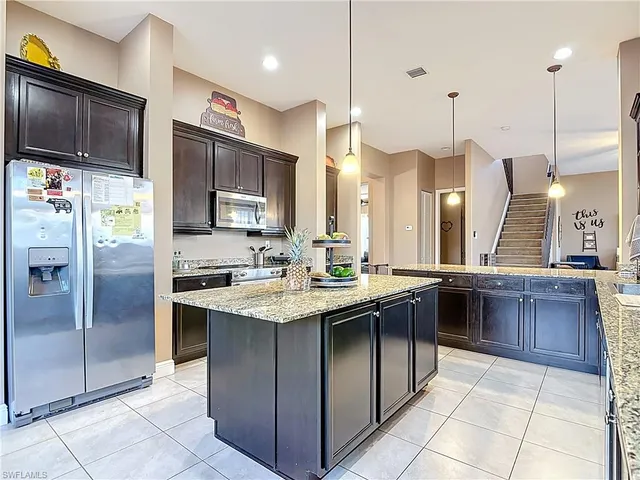 a kitchen with stainless steel appliances granite countertop a sink counter space cabinets and stainless steel appliances