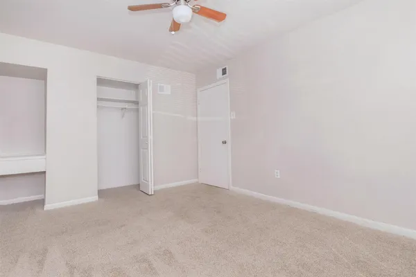 an empty room with a ceiling fan