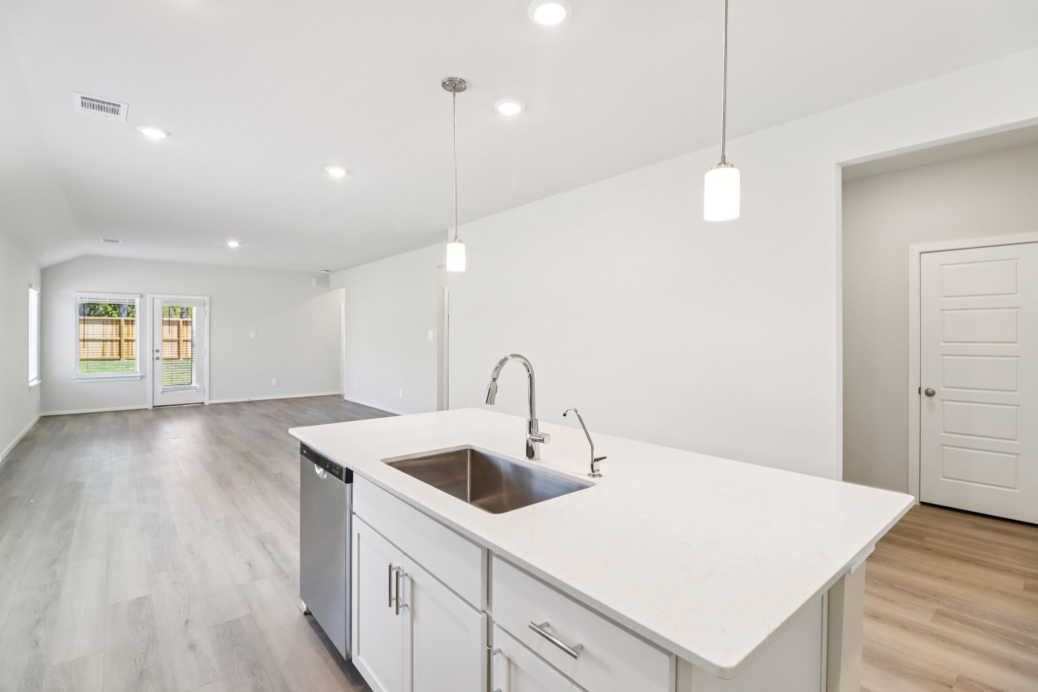 16273 Parish Pointe Court Conroe, TX 77302 - Photo 10 of 29 a kitchen with a sink a stove and wooden floor