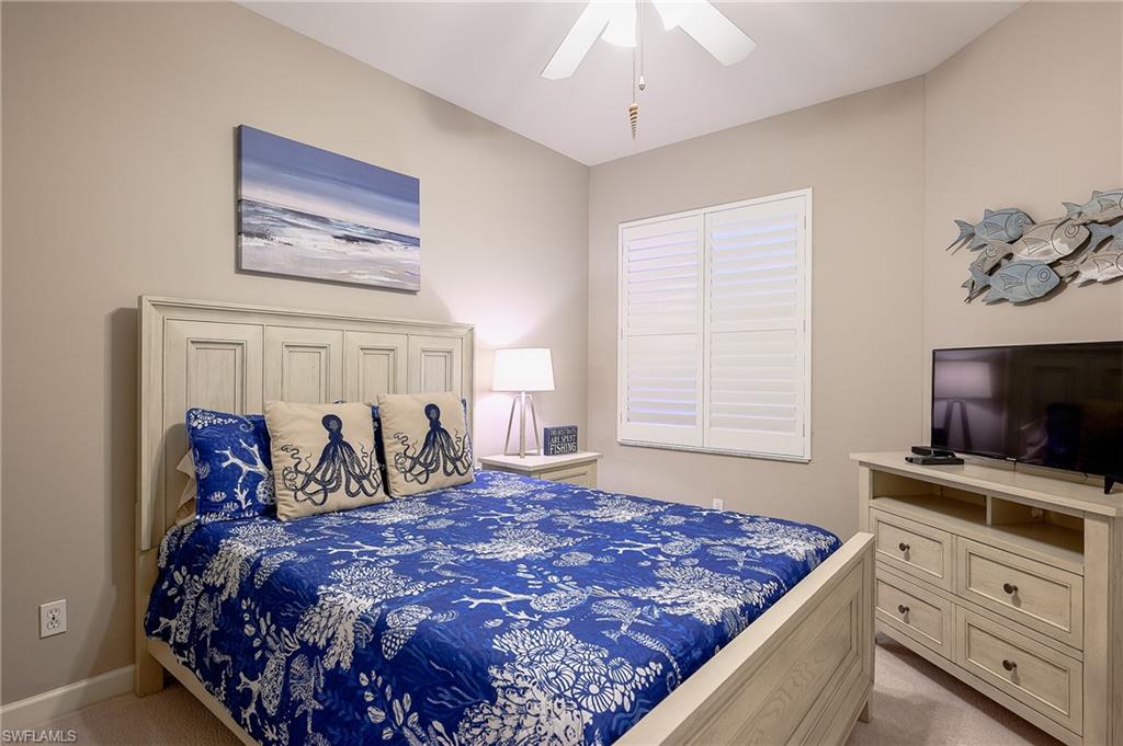2371 Ravenna Boulevard, Unit 101 Naples, FL 34109 - Photo 17 of 44 Bedroom featuring light carpet and ceiling fan