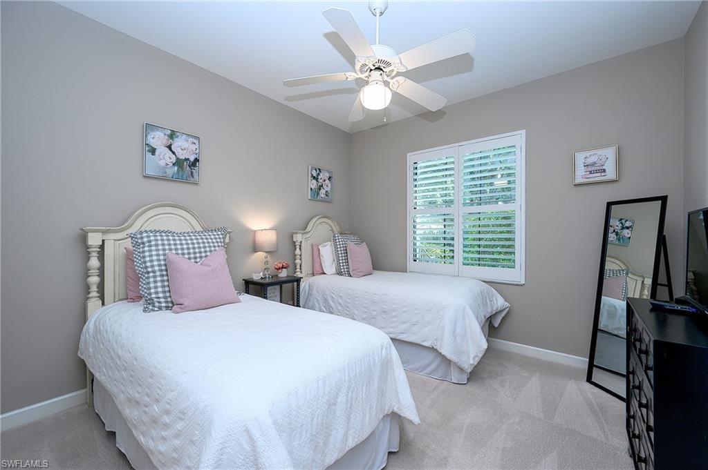 2371 Ravenna Boulevard, Unit 101 Naples, FL 34109 - Photo 18 of 44 Bedroom featuring ceiling fan and light colored carpet