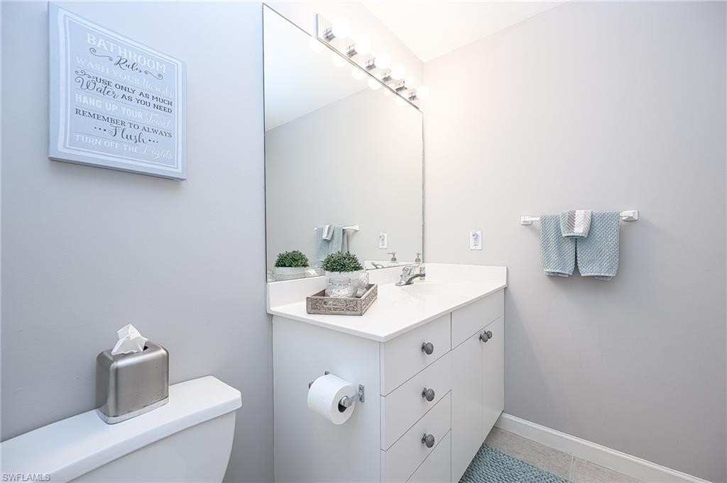 2371 Ravenna Boulevard, Unit 101 Naples, FL 34109 - Photo 20 of 44 Bathroom with tile patterned flooring, vanity, and toilet