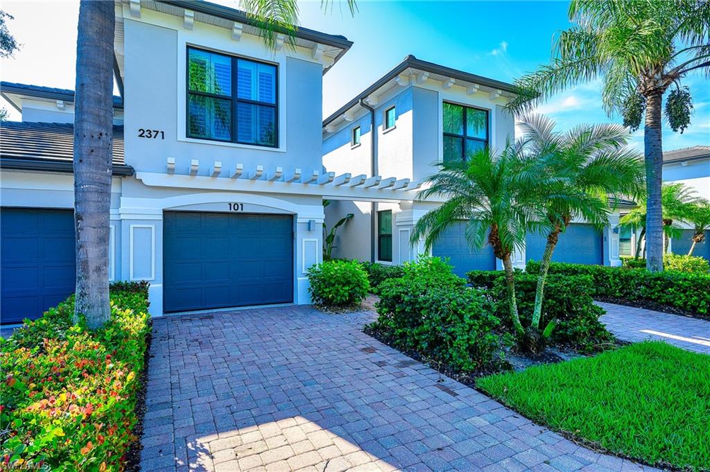 2371 Ravenna Boulevard, Unit 101 Naples, FL 34109 - Photo 2 of 44 View of front of home featuring a garage