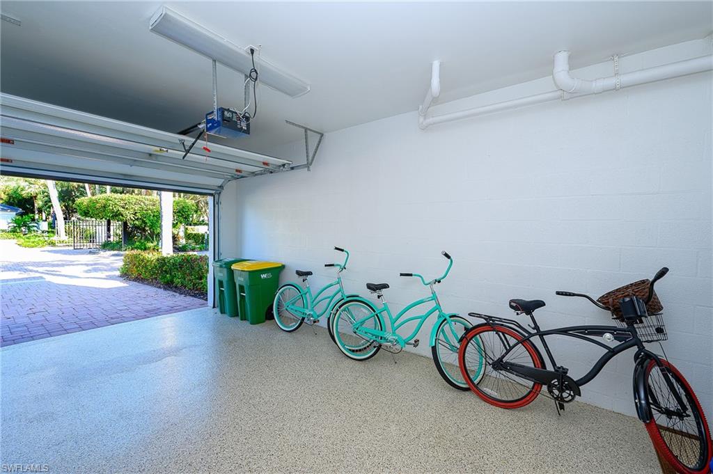 2371 Ravenna Boulevard, Unit 101 Naples, FL 34109 - Photo 25 of 44 Garage featuring a garage door opener