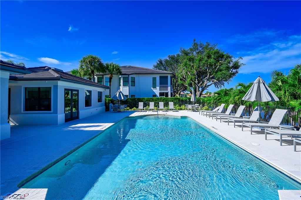 2371 Ravenna Boulevard, Unit 101 Naples, FL 34109 - Photo 29 of 44 View of swimming pool with a patio area