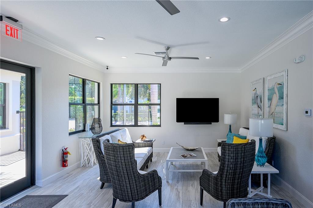 2371 Ravenna Boulevard, Unit 101 Naples, FL 34109 - Photo 34 of 44 Living room featuring ceiling fan, light hardwood / wood-style flooring, and ornamental molding