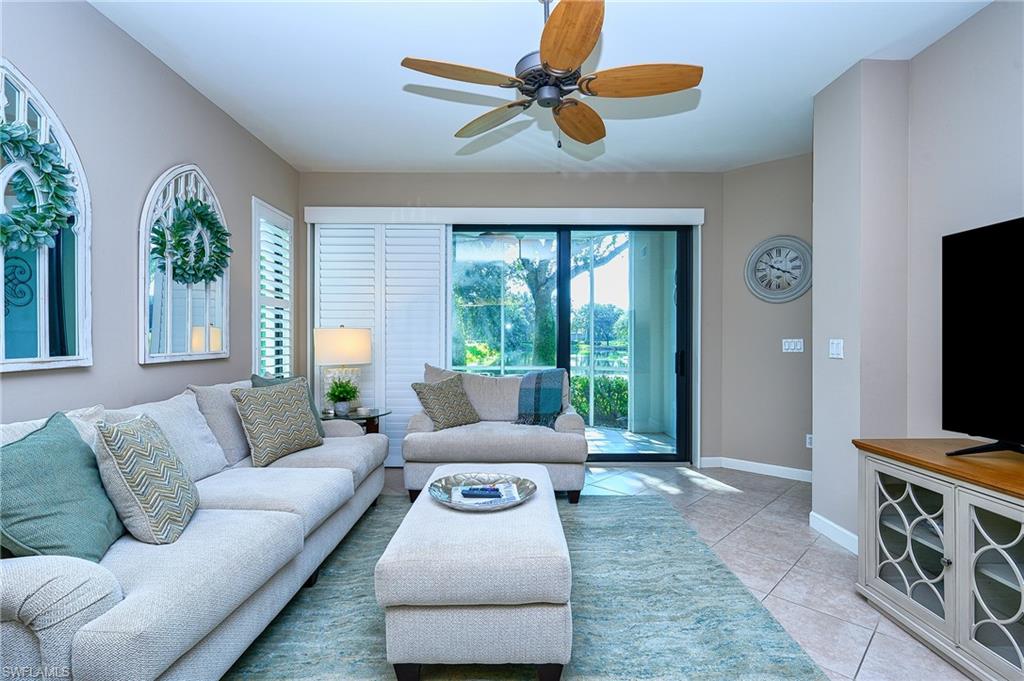 2371 Ravenna Boulevard, Unit 101 Naples, FL 34109 - Photo 4 of 44 Living room featuring ceiling fan and light tile patterned floors