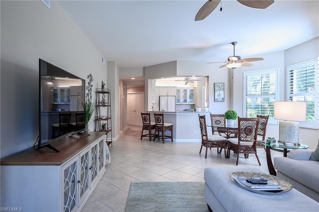2371 Ravenna Boulevard, Unit 101 Naples, FL 34109 - Photo 5 of 44 Living room with light tile patterned flooring and ceiling fan