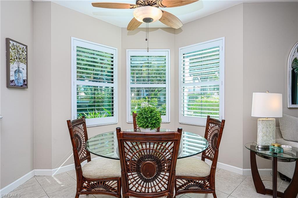 2371 Ravenna Boulevard, Unit 101 Naples, FL 34109 - Photo 7 of 44 Tiled dining room featuring ceiling fan and plenty of natural light