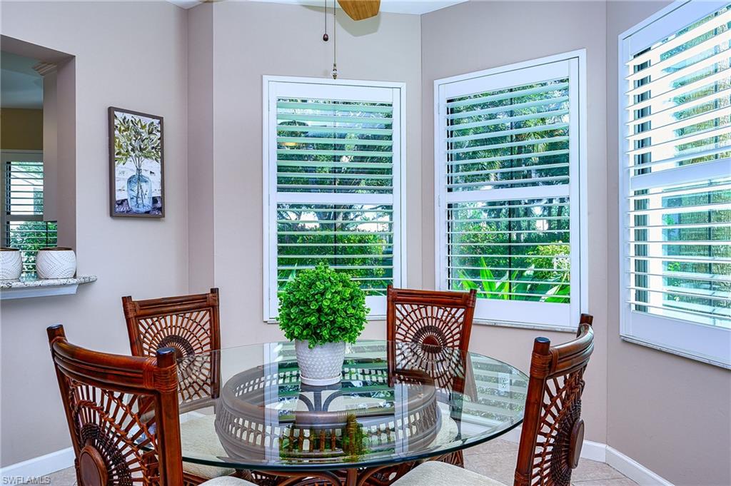2371 Ravenna Boulevard, Unit 101 Naples, FL 34109 - Photo 8 of 44 Dining area featuring a healthy amount of sunlight and ceiling fan