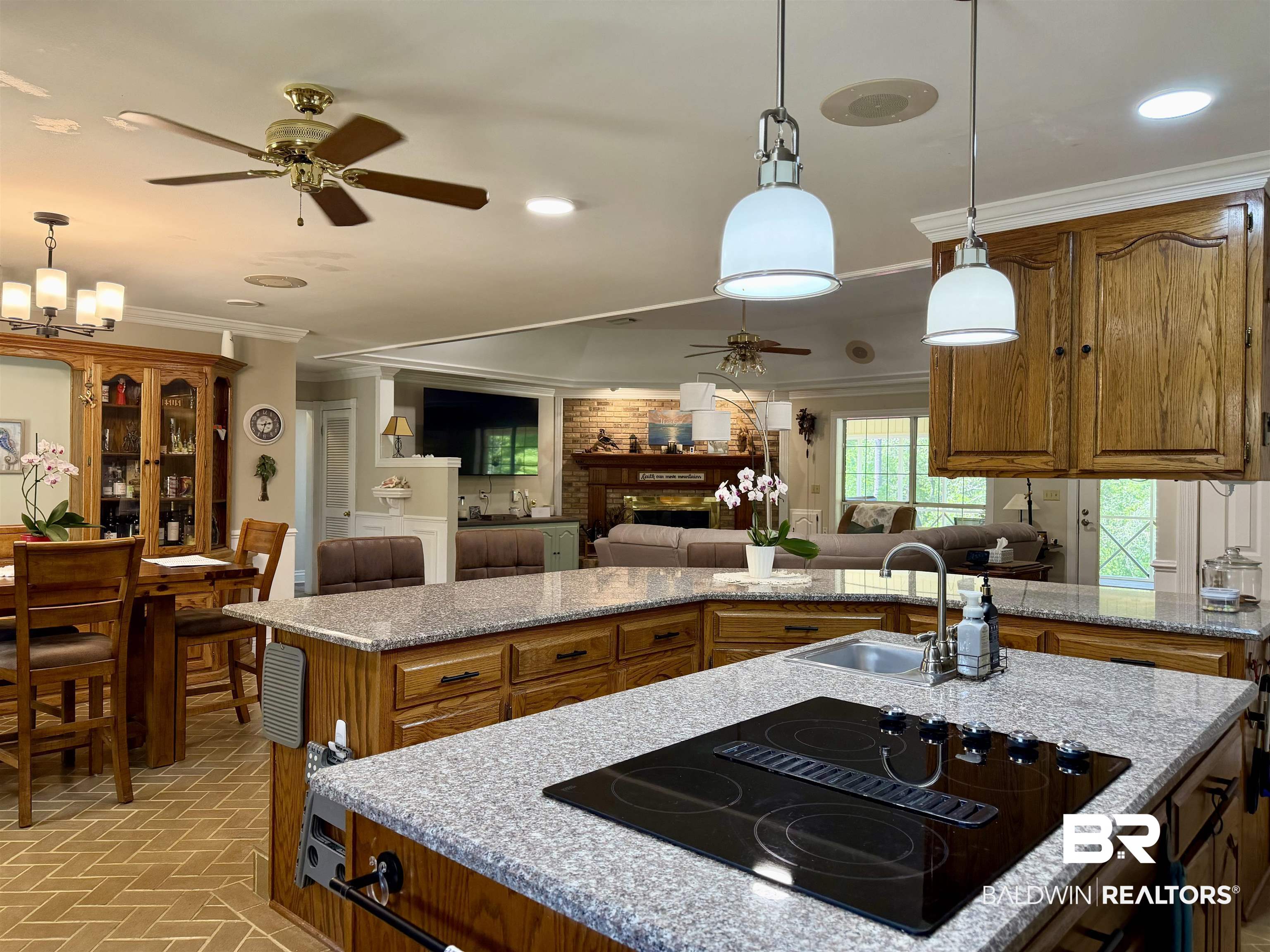 2944 Appleton Road Brewton, AL 36426 - Photo 64 of 65 Kitchen with ceiling fan, crown molding, open floor plan, black electric cooktop, and hanging light fixtures