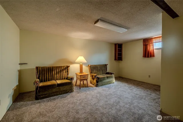 a view of a bedroom with furniture and a ceiling fan