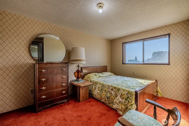 a bedroom with a bed and a dresser