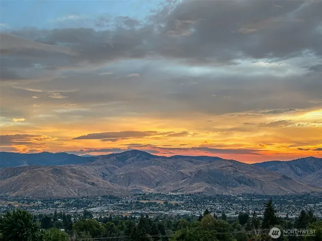 a view of an ocean and mountains