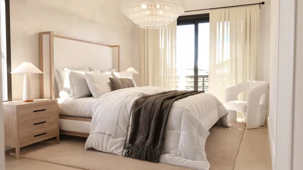 a bedroom with a bed and a large window