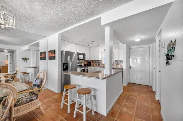 a large kitchen with a table and chairs