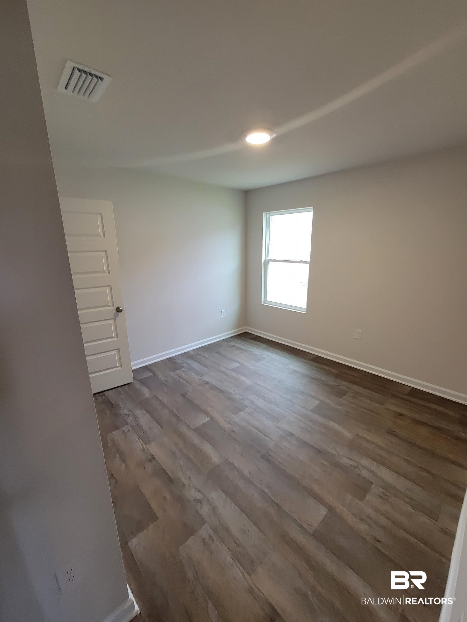 24625 Ponder Loop Loxley, AL 36551 - Photo 12 of 30 Unfurnished room with dark wood-type flooring