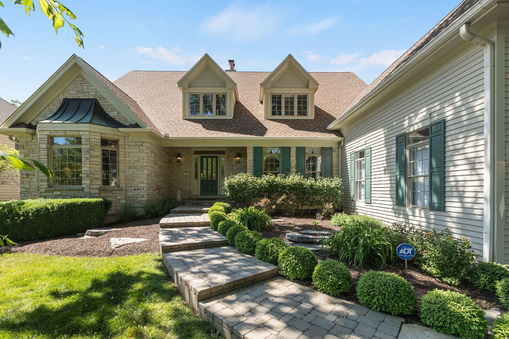 209 Carriage Trail Barrington, IL 60010 - Photo 3 of 42 a front view of a house with a yard and outdoor seating