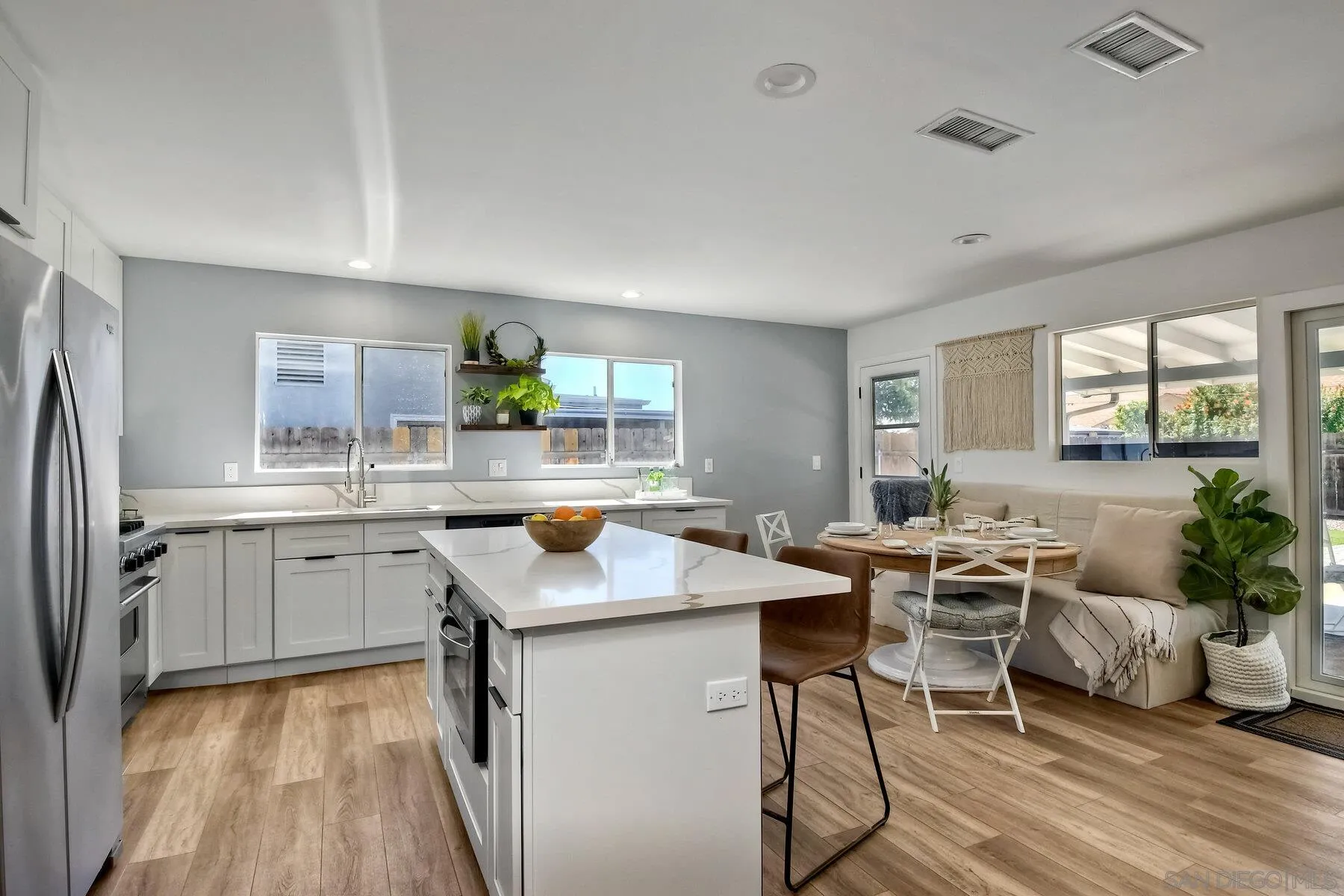 a kitchen with a table chairs refrigerator and microwave