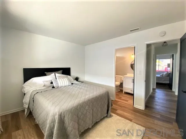 13360 Floral Avenue Poway, CA 92064 - Photo 20 of 37 a bedroom with a bed and wooden floor