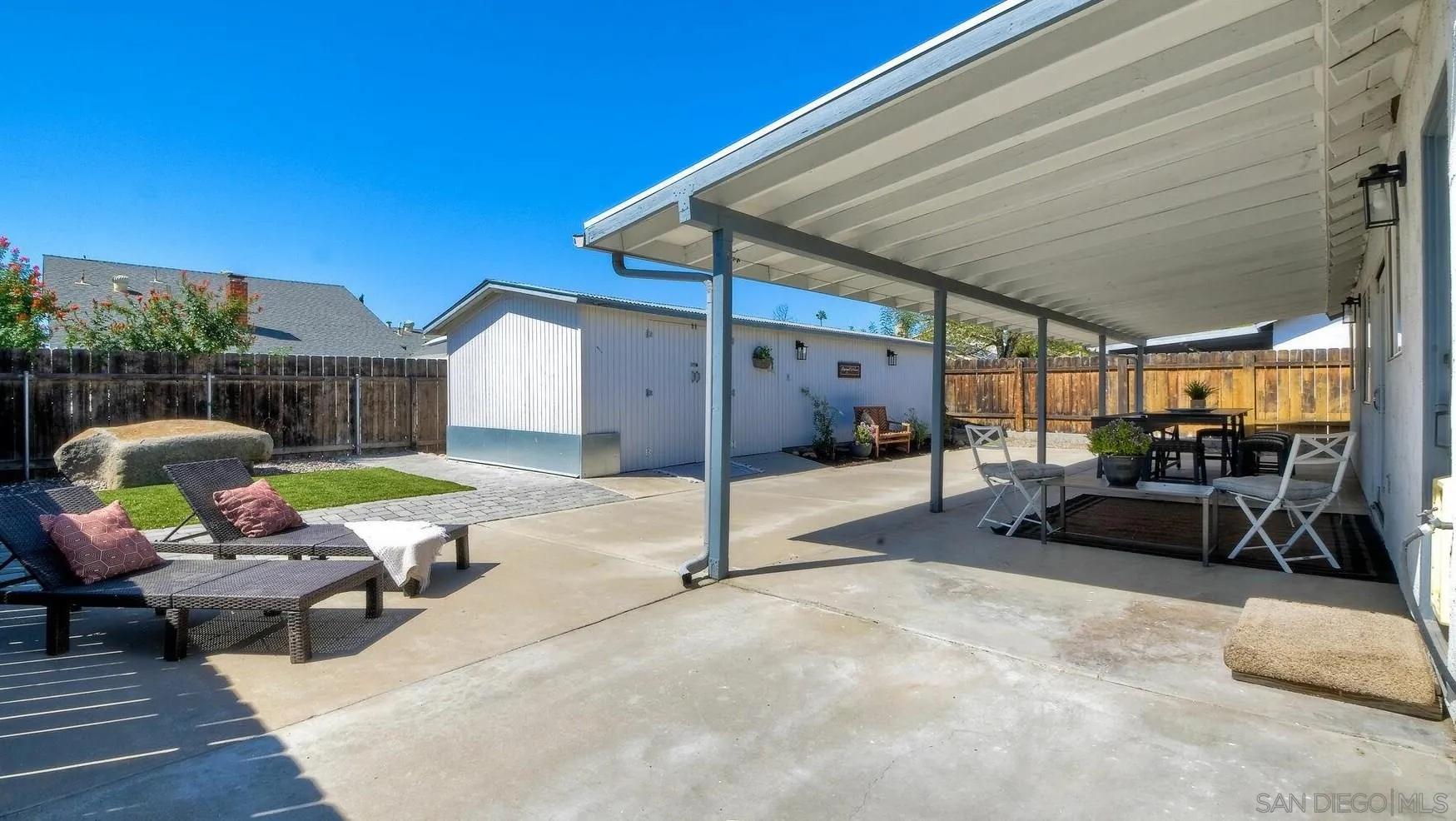 13360 Floral Avenue Poway, CA 92064 - Photo 24 of 37 a view of a patio with table and chairs a barbeque with wooden fence and roof
