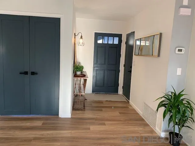 13360 Floral Avenue Poway, CA 92064 - Photo 5 of 37 a view of a hallway with wooden floor and a living room