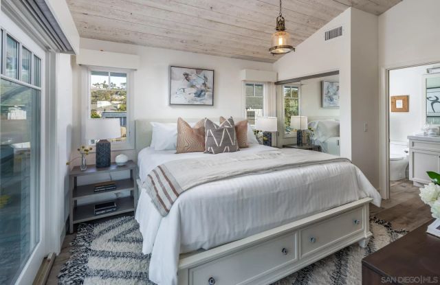 a bathroom with a granite countertop sink a toilet and shower