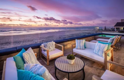 a roof deck with couches and a table