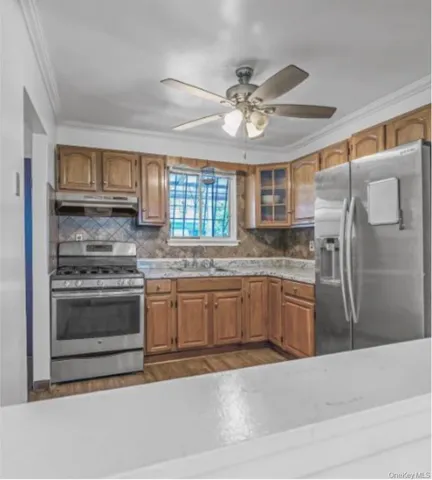 a kitchen with stainless steel appliances granite countertop a stove sink and refrigerator
