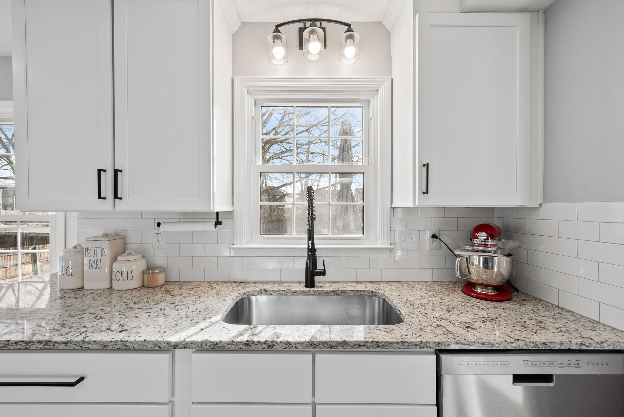 504 Eysian Road Clarksville, TN 37040 - Photo 12 of 41 a kitchen with granite countertop a sink stainless steel appliances white cabinets and a window