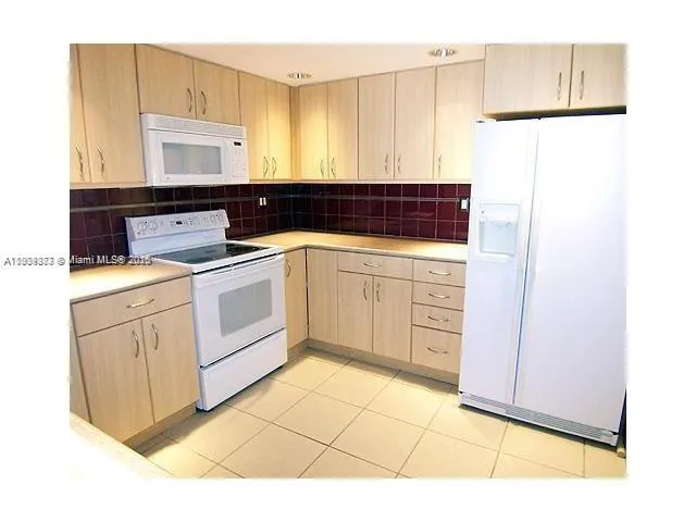 a kitchen with a sink cabinets and appliances