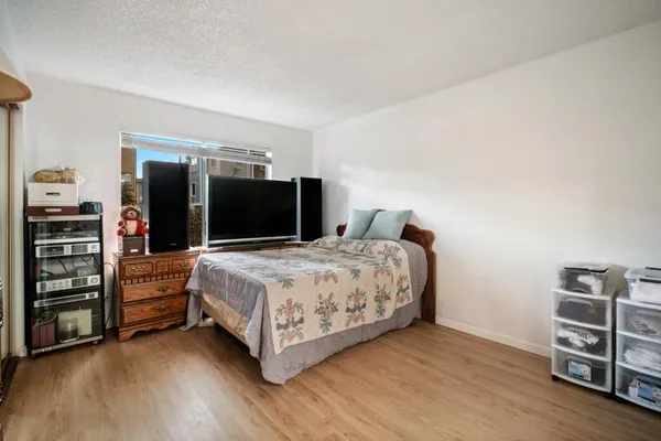 a bedroom with a bed and a television
