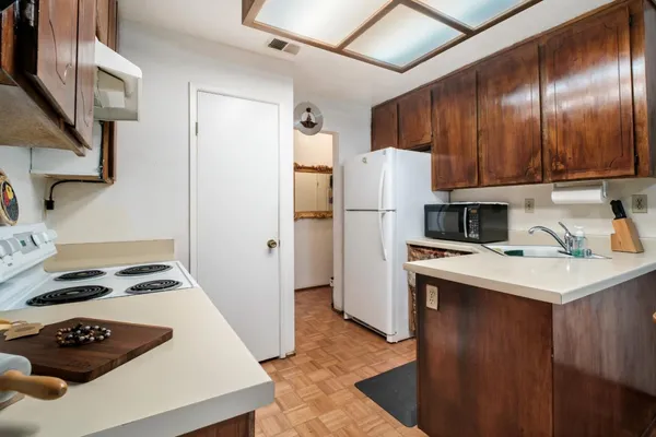 a kitchen with a refrigerator a stove a sink and a stove