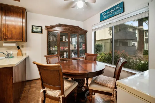 a dining room with furniture wooden floor and a chandelier