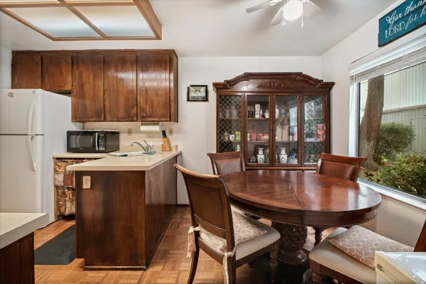 a kitchen with a table chairs and refrigerator