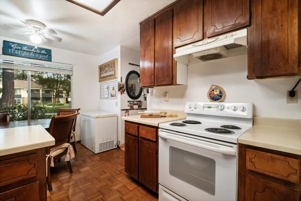 a kitchen with a stove cabinets and a sink