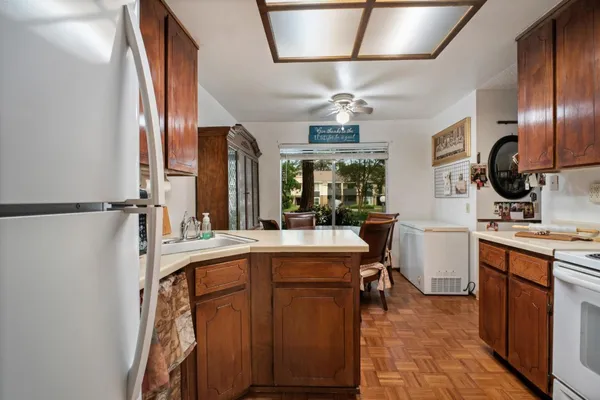 a view of a kitchen sink appliances and cabinets