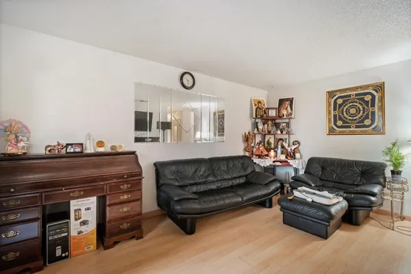 a living room with furniture and a piano