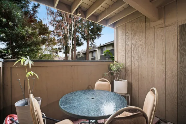 a view of a room that has a table chairs and a wooden floor