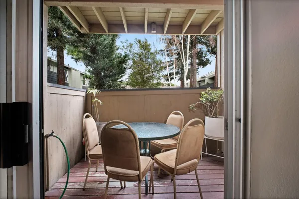 a view of a chair and table in the balcony