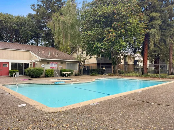 a view of a house with swimming pool and a yard in the patio