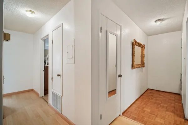 a view of hallway with wooden floor