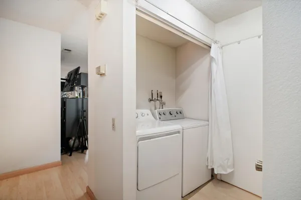a view of walk in closet with clothes