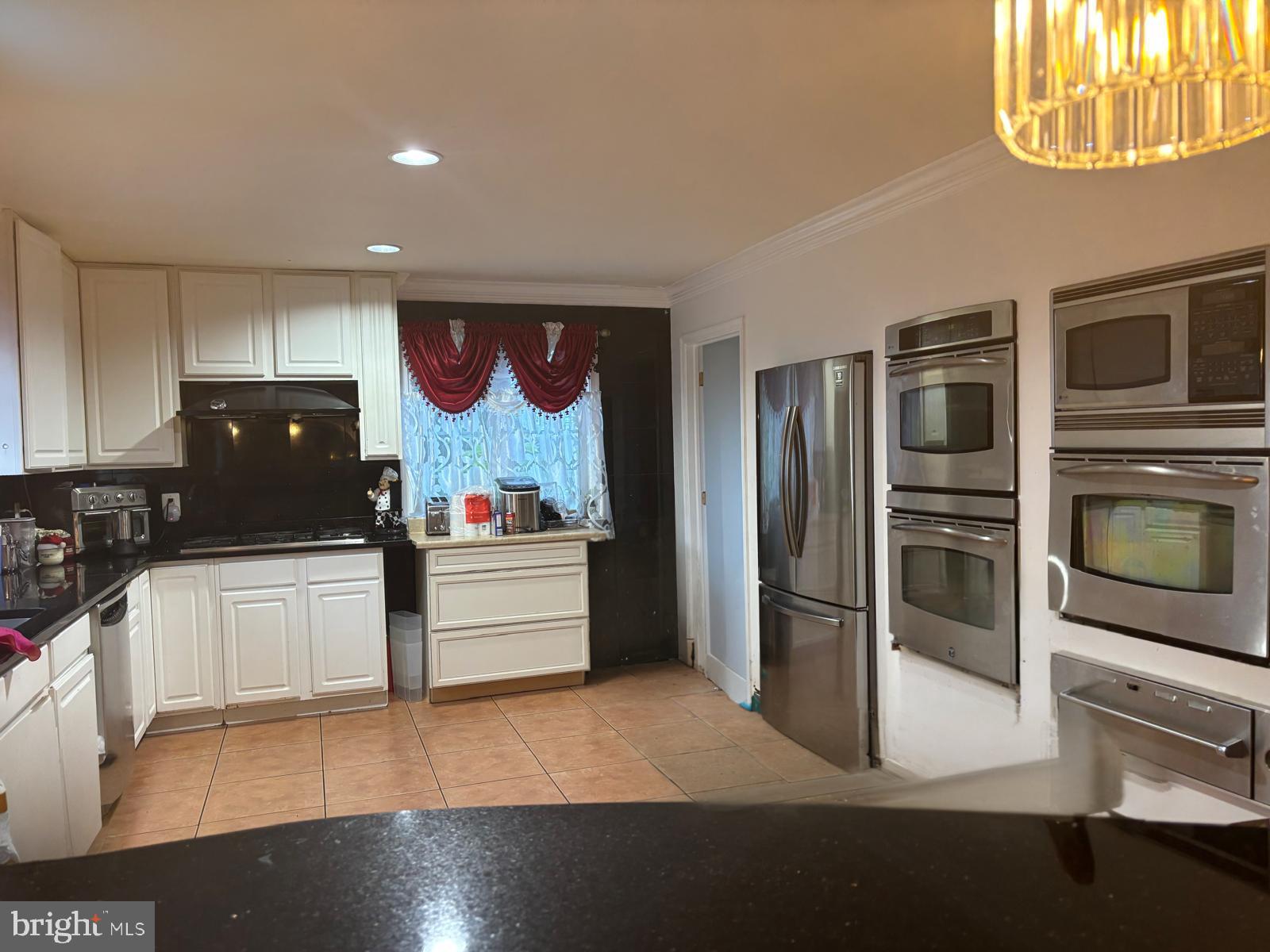3610 64th Avenue Landover, MD 20785 - Photo 7 of 20 a kitchen with stainless steel appliances kitchen island granite countertop a refrigerator and a stove top oven