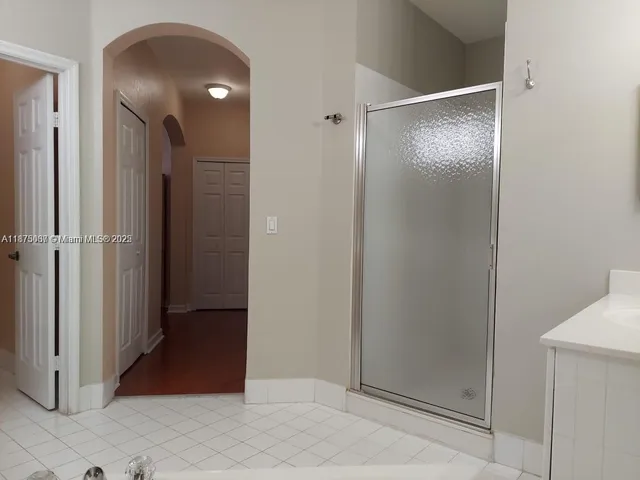 a view of a bathroom with a glass door shower