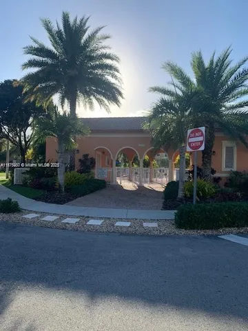 a front view of a house with yard and tree s
