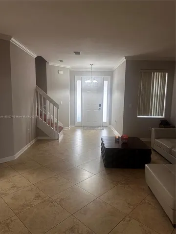 a living room with furniture and a lamp